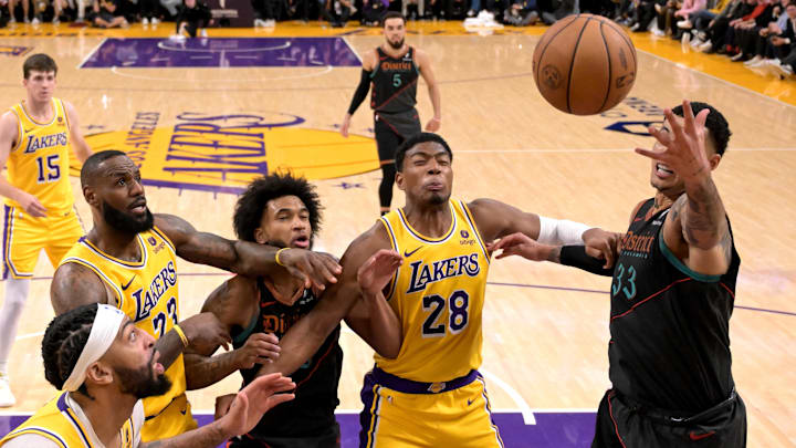 Feb 29, 2024; Los Angeles, California, USA;   Los Angeles Lakers forward LeBron James (23), Washington Wizards forward Marvin Bagley III (35), Los Angeles Lakers forward Rui Hachimura (28) and Washington Wizards forward Kyle Kuzma (33) battle for a rebound in the second half at Crypto.com Arena. Mandatory Credit: Jayne Kamin-Oncea-Imagn Images