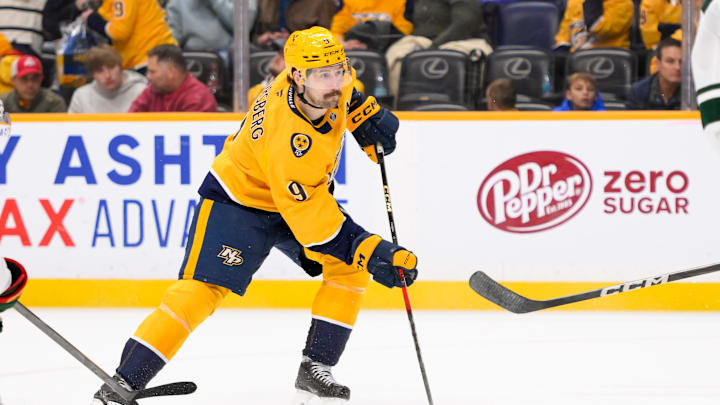 Jan 18, 2025; Nashville, Tennessee, USA;  Nashville Predators left wing Filip Forsberg (9) skates with the puck against the Minnesota Wild during the third period at Bridgestone Arena. Mandatory Credit: Steve Roberts-Imagn Images