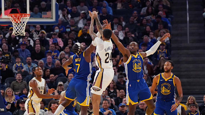 New Orleans Pelicans guard Jordan Hawkins (24) shoots over Golden State Warriors guard Buddy Hield (7) and forward Jonathan Kuminga (00) during the third quarter at Chase Center. Mandatory Credit: David Gonzales-Imagn Images