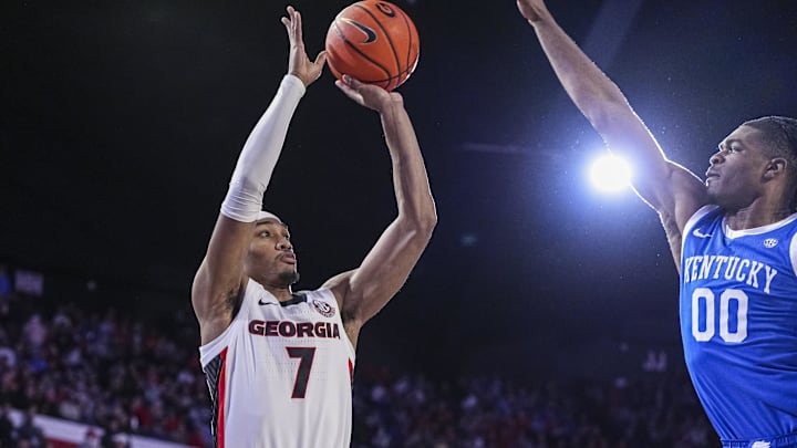 Jan 7, 2025; Athens, Georgia, USA; Georgia Bulldogs guard Tyrin Lawrence (7) shoots over Kentucky Wildcats guard Otega Oweh (00)  during the first half at Stegeman Coliseum. Mandatory Credit: Dale Zanine-Imagn Images