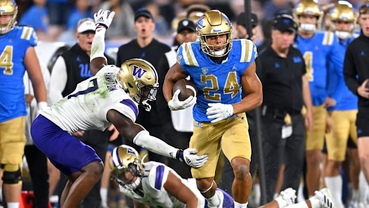 Sep 30, 2022; Pasadena, California, USA; UCLA Bruins running back Zach Charbonnet (24) gets past Washington Huskies linebacker Dominique Hampton (7) for a first down in the first half at the Rose Bowl. Mandatory Credit: Jayne Kamin-Oncea-Imagn Images Sep 30, 2022; Pasadena, California, USA; UCLA Bruins running back Zach Charbonnet (24) gets past Washington Huskies linebacker Dominique Hampton (7) for a first down in the first half at the Rose Bowl. Mandatory Credit: Jayne Kamin-Oncea-Imagn Images