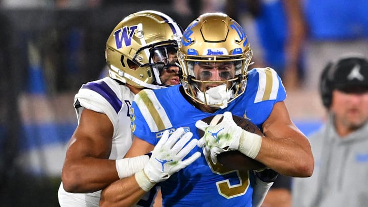 Sep 30, 2022; Pasadena, California, USA; UCLA Bruins wide receiver Jake Bobo (9) runs down the sideline for a first down after a complete pass in the first half before he is stopped by Washington Huskies safety Alex Cook (5) in the first half at the Rose Bowl. Mandatory Credit: Jayne Kamin-Oncea-Imagn Images