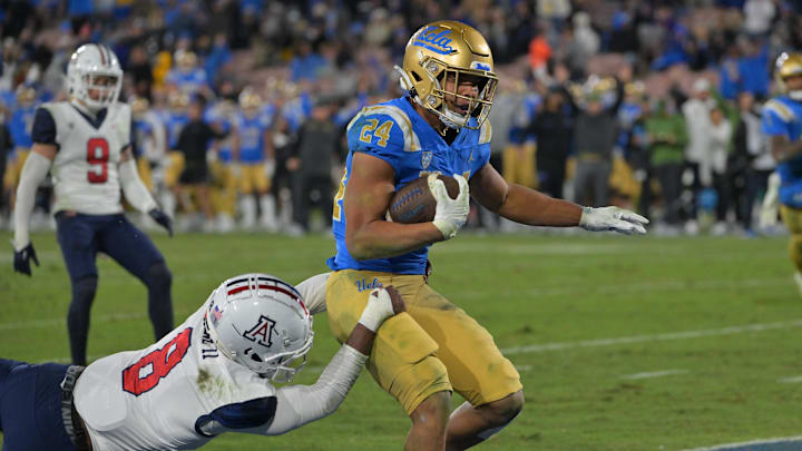 Nov 12, 2022; Pasadena, California, USA; UCLA Bruins running back Zach Charbonnet (24) carries the ball just into the end zone for a touchdown in the second half against the Arizona Wildcats at the Rose Bowl. Mandatory Credit: Jayne Kamin-Oncea-Imagn Images
