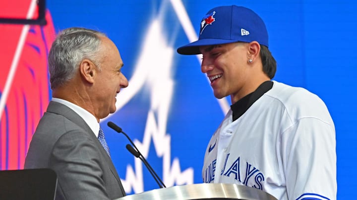 Brandon Barriera is congratulated by Rob Manfred, commissioner of Major League Baseball, after he was selected by the Toronto Blue Jays as the 23th player in the MLB draft at XBox Plaza at LA Live in 2022.