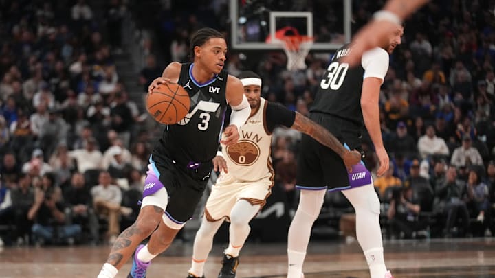 Nov 24, 2025; San Francisco, California, USA; Utah Jazz guard Keyonte George (3) dribbles past Golden State Warriors guard Gary Payton II (0) in the third quarter at the Chase Center. Mandatory Credit: Cary Edmondson-Imagn Images