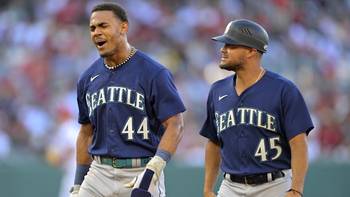 Seattle Mariners center fielder Julio Rodriguez (44) yells as he walks off the field next to first base coach Kristopher Negron (45) after a stolen base was called back because of umpire interference in the first inning against the Los Angeles Angels at Angel Stadium in 2023.