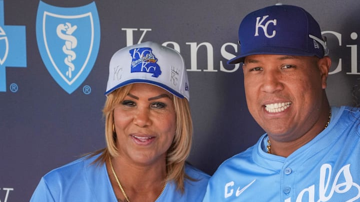 Jul 21, 2024; Kansas City, Missouri, USA; Kansas City Royals catcher Salvador Perez (13) poses for a photo with his mother Yild Diaz in the dugout prior to a game against the Chicago White Sox at Kauffman Stadium. Mandatory Credit: Denny Medley-Imagn Images