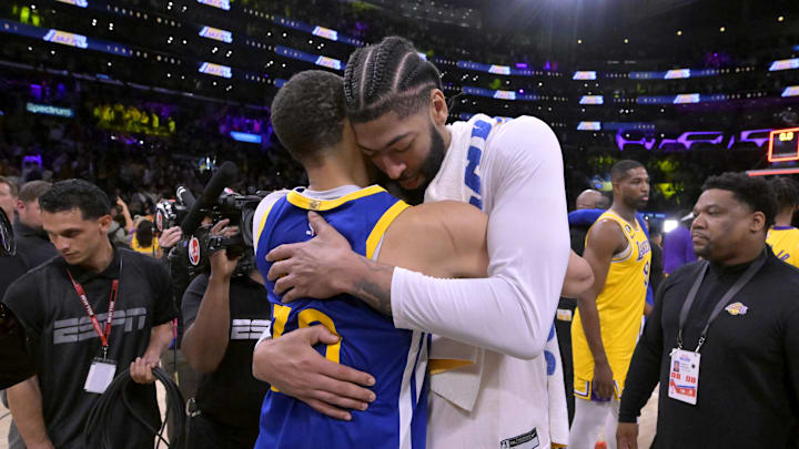 May 12, 2023; Los Angeles, California, USA; Los Angeles Lakers forward Anthony Davis (3) and Golden State Warriors guard Stephen Curry (30) embrace after game six of the 2023 NBA playoffs at Crypto.com Arena. 
