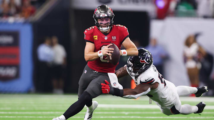 Sep 15, 2025; Houston, Texas, USA; Tampa Bay Buccaneers quarterback Baker Mayfield (6) attempts to evade a tackle from Houston Texans defensive end Danielle Hunter (55) during the fourth quarter at NRG Stadium. Mandatory Credit: Troy Taormina-Imagn Images