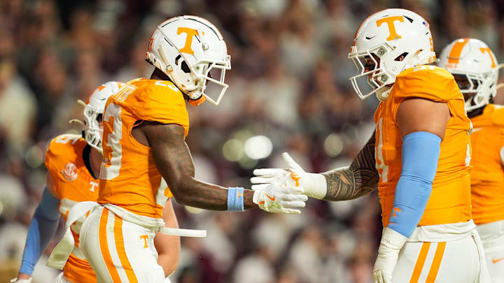 Nov 9, 2024; Knoxville, Tennessee, USA; Tennessee Volunteers defensive back Boo Carter (23) and defensive lineman Jaxson Moi (51) celebrate after a play against the Mississippi State Bulldogs during the first half at Neyland Stadium. Mandatory Credit: Caitie McMekin/USA TODAY Network via Imagn Images
