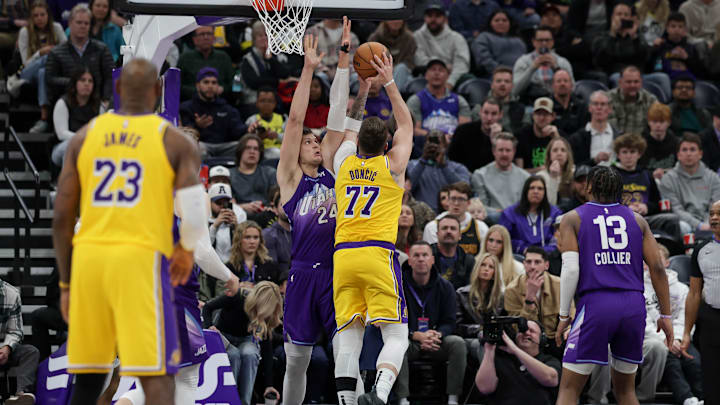 Feb 12, 2025; Salt Lake City, Utah, USA;  Los Angeles Lakers guard Luka Doncic (77) shoots against Utah Jazz center Walker Kessler (24) during the second half at Delta Center. Mandatory Credit: Chris Nicoll-Imagn Images