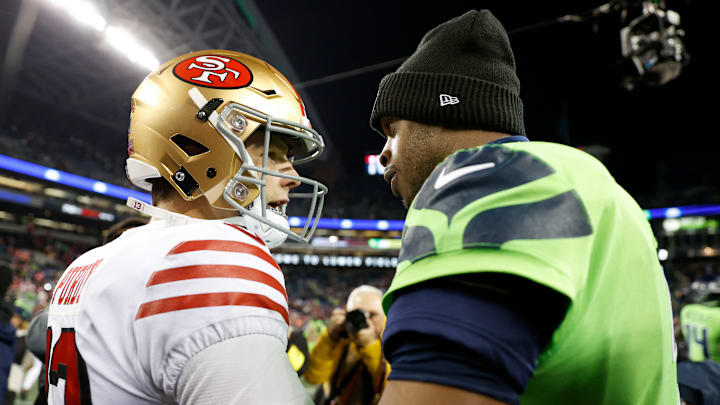 San Francisco 49ers quarterback Brock Purdy (L) with Seattle Seahawks quarterback Geno Smith (R)