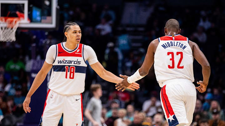 Mar 1, 2025; Charlotte, North Carolina, USA; Washington Wizards forward Kyshawn George (18) celebrates with forward Khris Middleton (32) during the third quarter against the Charlotte Hornets at Spectrum Center. Mandatory Credit: Scott Kinser-Imagn Images