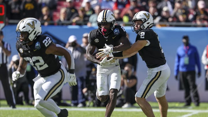 Dec 31, 2025; Tampa, FL, USA; Vanderbilt Commodores quarterback Diego Pavia (2) hands off to wide receiver Tre Richardson (6) against the Iowa Hawkeyes in the second quarter during the ReliaQuest Bowl at Raymond James Stadium. Mandatory Credit: Nathan Ray Seebeck-Imagn Images