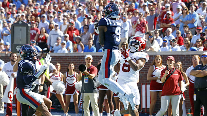 Oct 26, 2024; Oxford, Mississippi, USA; Mississippi Rebels defensive back Trey Amos (9) catches the ball as he steps out of bounds over Oklahoma Sooners running back Taylor Tatum (8) during the first half at Vaught-Hemingway Stadium. Mandatory Credit: Petre Thomas-Imagn Images