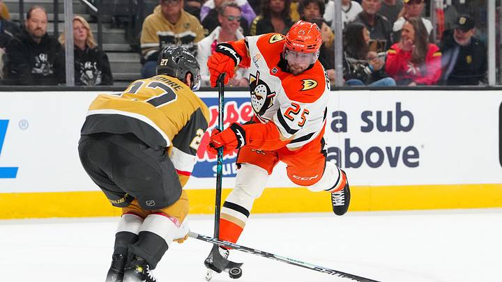May 4, 2026; Las Vegas, Nevada, USA; Anaheim Ducks center Ryan Poehling (25) shoots against the block attempt of Vegas Golden Knights defenseman Shea Theodore (27) during the second period of game one of the second round of the 2026 Stanley Cup Playoffs at T-Mobile Arena. Mandatory Credit: Stephen R. Sylvanie-Imagn Images