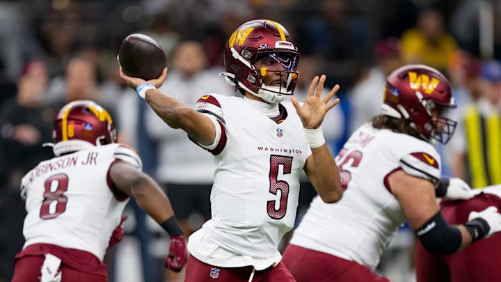 Dec 15, 2024; New Orleans, Louisiana, USA; Washington Commanders quarterback Jayden Daniels (5) throws against the New Orleans Saints during the first half at Caesars Superdome. Mandatory Credit: Matthew Hinton-Imagn Images