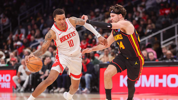 Jan 29, 2026; Atlanta, Georgia, USA; Houston Rockets forward Jabari Smith Jr. (10) drives on Atlanta Hawks forward Corey Kispert (24) in the fourth quarter at State Farm Arena. Mandatory Credit: Brett Davis-Imagn Images