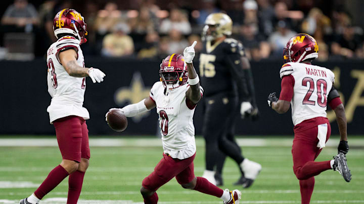 Dec 15, 2024; New Orleans, Louisiana, USA; Washington Commanders cornerback Mike Sainristil (0) celebrates an interception against New Orleans Saints running back Alvin Kamara (41) during the first half at Caesars Superdome. Mandatory Credit: Matthew Hinton-Imagn Images Dec 15, 2024; New Orleans, Louisiana, USA; Washington Commanders cornerback Mike Sainristil (0) celebrates an interception against New Orleans Saints running back Alvin Kamara (41) during the first half at Caesars Superdome. Mandatory Credit: Matthew Hinton-Imagn Images