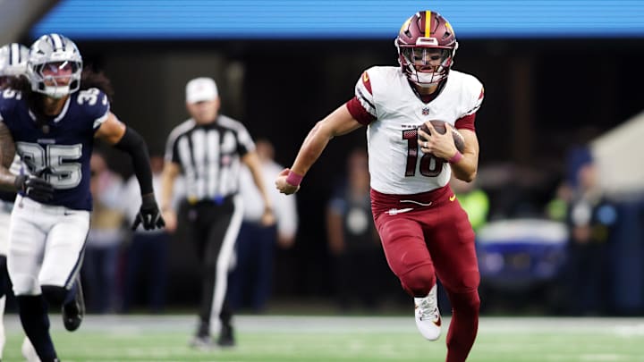 Washington Commanders quarterback Marcus Mariota (18) runs for a first down against the Dallas Cowboys during the fourth quarter at AT&T Stadium last season.