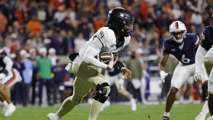 Nov 8, 2025; Charlottesville, Virginia, USA; Wake Forest Demon Deacons quarterback Robby Ashford (2) runs with the ball against the Virginia Cavaliers during the first half at Scott Stadium. Mandatory Credit: Amber Searls-Imagn Images