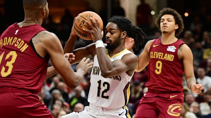 Nov 20, 2024; Cleveland, Ohio, USA; New Orleans Pelicans guard Antonio Reeves (12) drives to the basket against Cleveland Cavaliers center Tristan Thompson (13) during the second half at Rocket Mortgage FieldHouse. Mandatory Credit: Ken Blaze-Imagn Images