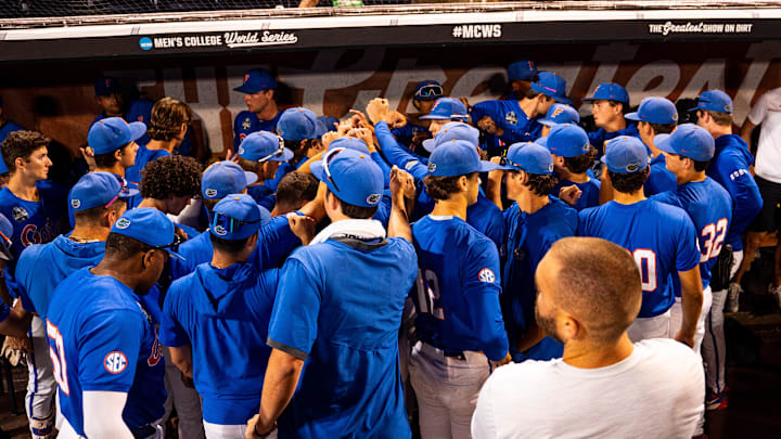 Jun 19, 2024; Omaha, NE, USA; The Florida Gators meet in the dugout after being defeated by the Texas A&M Aggies at Charles Schwab Field Omaha. Mandatory Credit: Dylan Widger-Imagn Images