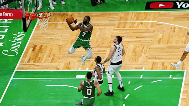 Jun 17, 2024; Boston, Massachusetts, USA; Boston Celtics guard Jaylen Brown (7) shoots the ball against Dallas Mavericks guard Luka Doncic (77) in game five of the 2024 NBA Finals at TD Garden. Mandatory Credit: Peter Casey-Imagn Images