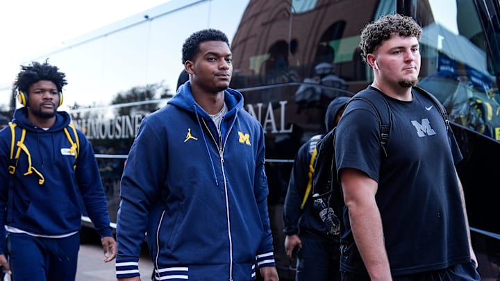 Michigan defensive back Will Johnson (2), center, and defensive lineman Mason Graham (55) walk towards locker room as the team arrive before the Michigan State game at Michigan Stadium in Ann Arbor on Saturday, Oct. 26, 2024.
