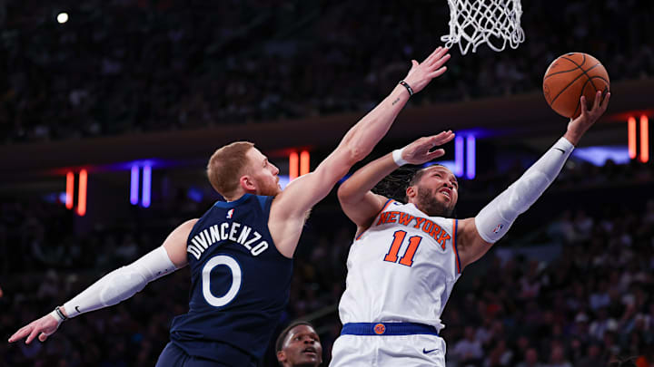 Oct 13, 2024; New York, New York, USA; New York Knicks guard Jalen Brunson (11) drives to the basket as Minnesota Timberwolves guard Donte DiVincenzo (0) defends during the first half at Madison Square Garden. Mandatory Credit: Vincent Carchietta-Imagn Images