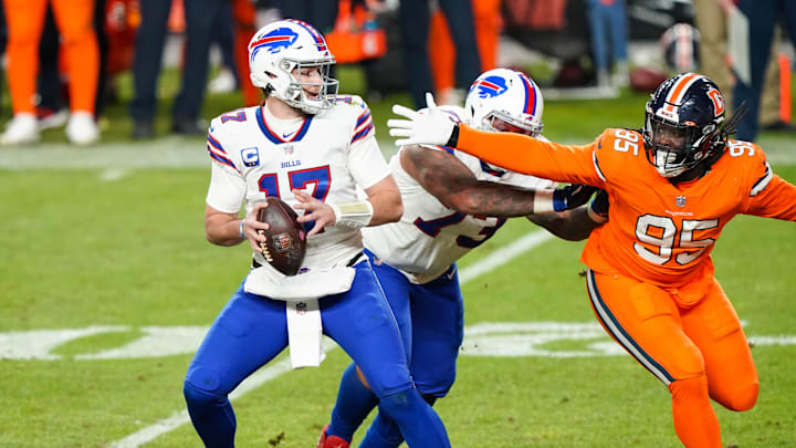 Dec 19, 2020; Denver, Colorado, USA; Buffalo Bills quarterback Josh Allen (17) looks to throw against Denver Broncos defensive tackle McTelvin Agim (95) during the third quarter at Empower Field