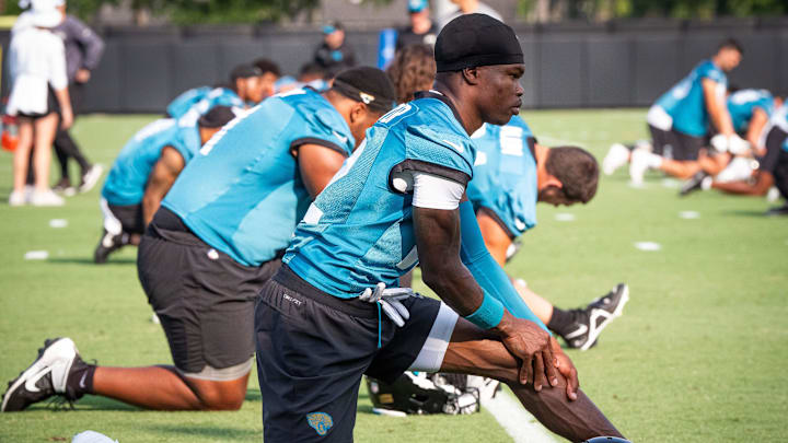 Jacksonville Jaguars wide receiver Travis Hunter (12) stretches during the seventh organized team activity at the Miller Electric Center in Jacksonville, Fla. Monday, June 2, 2025. [Doug Engle/Florida Times-Union]