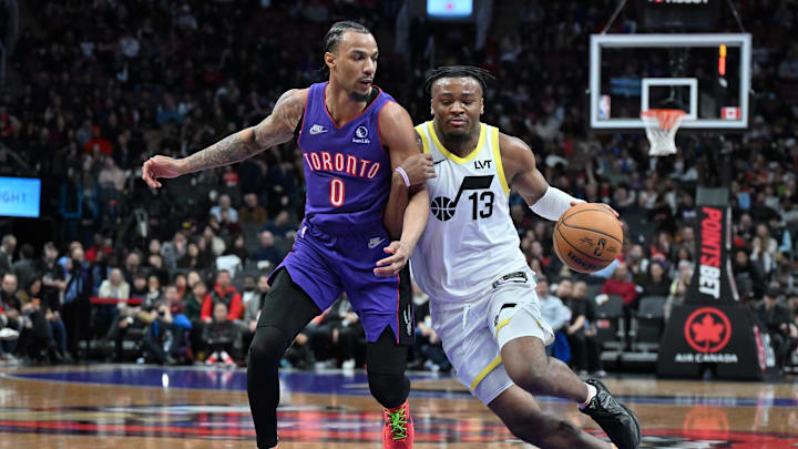 Mar 7, 2025; Toronto, Ontario, CAN;  Utah Jazz guard Isaiah Collier (13) dribbles the ball as Toronto Raptors guard AJ Lawson (0) defends in the second half at Scotiabank Arena. Mandatory Credit: Dan Hamilton-Imagn Images