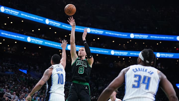Apr 29, 2025; Boston, Massachusetts, USA; Boston Celtics center Kristaps Porzingis (8) shoots the ball against Orlando Magic guard Cory Joseph (10) in the third quarter during game five of first round for the 2025 NBA Playoffs at TD Garden. Mandatory Credit: David Butler II-Imagn Images