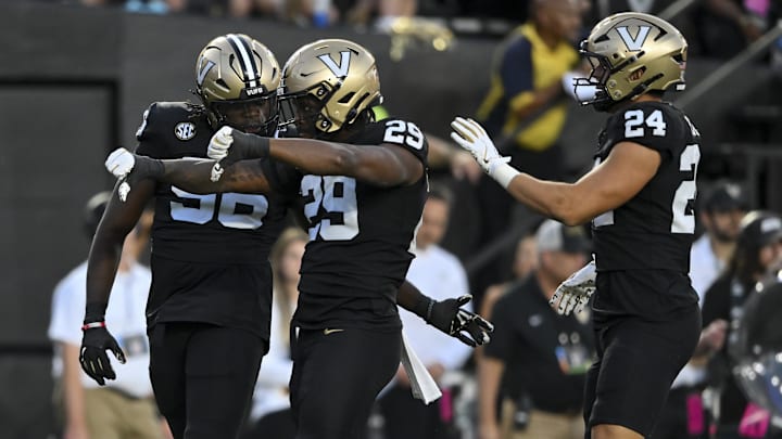 Aug 30, 2025; Nashville, Tennessee, USA;  Vanderbilt Commodores edge rusher  Miles Caper celebrates the tackle for loss with linebacker Nick Rinaldi (24) and defensive lineman Khordae Sydnor (96) during the first half at FirstBank Stadium. Mandatory Credit: Steve Roberts-Imagn Images
