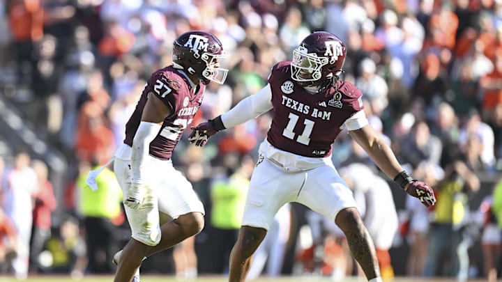 Dec 20, 2025; College Station, TX, USA; Texas A&M Aggies linebacker Daymion Sanford (27) reacts with defensive tackle Tyler Onyedim (11) after recovering a fumble against the Miami Hurricanes during the second half of the first round game of the CFP National Playoff at Kyle Field. Mandatory Credit: Maria Lysaker-Imagn Images