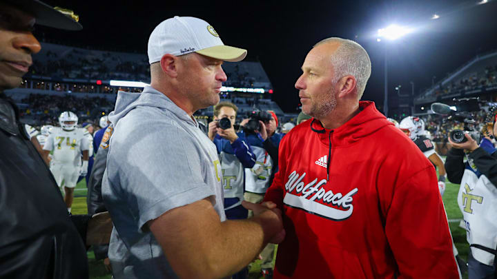 Nov 21, 2024; Atlanta, Georgia, USA; Georgia Tech Yellow Jackets head coach Brent Key talks to North Carolina State Wolfpack head coach Dave Doeren after a game at Bobby Dodd Stadium at Hyundai Field. Mandatory Credit: Brett Davis-Imagn Images

