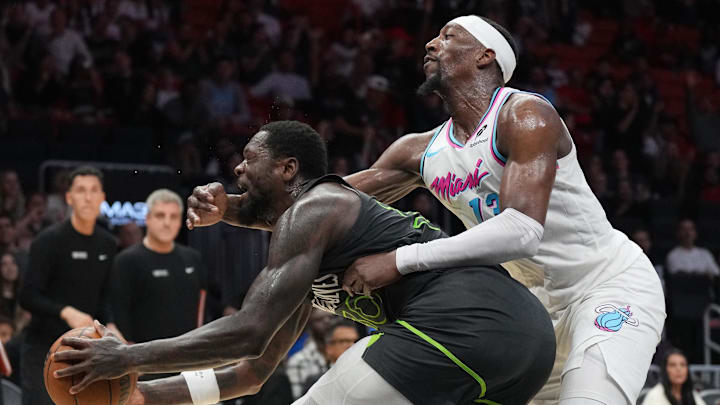 Mar 7, 2025; Miami, Florida, USA;  Miami Heat center Bam Adebayo (13) fouls Minnesota Timberwolves forward Julius Randle (30) during the second half at Kaseya Center. Mandatory Credit: Jim Rassol-Imagn Images
