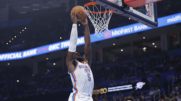 Oct 9, 2025; Oklahoma City, Oklahoma, USA; Oklahoma City Thunder guard Luguentz Dort (5) goes up for a dunk against the Charlotte Hornets during the second quarter of a game between the Charlotte Hornets and the Oklahoma City Thunder at Paycom Center. Mandatory Credit: Alonzo Adams-Imagn Images