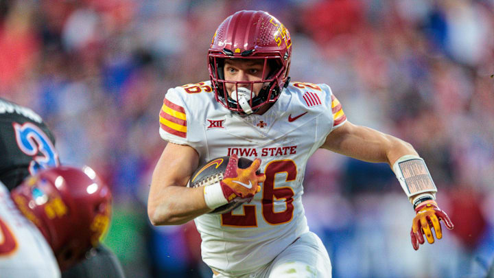 Nov 9, 2024; Kansas City, Missouri, USA; Iowa State Cyclones running back Carson Hansen (26) runs the ball during the fourth quarter against the Kansas Jayhawks at GEHA Field at Arrowhead Stadium. Mandatory Credit: William Purnell-Imagn Images