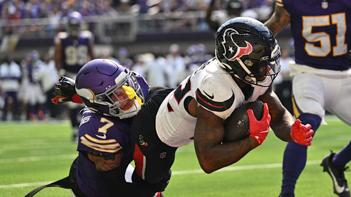 Sep 22, 2024; Minneapolis, Minnesota, USA; Houston Texans running back Cam Akers (22) runs for a touchdown as Minnesota Vikings cornerback Byron Murphy Jr. (7) attempts to make the tackle during the third quarter at U.S. Bank Stadium. Mandatory Credit: Jeffrey Becker-Imagn Images