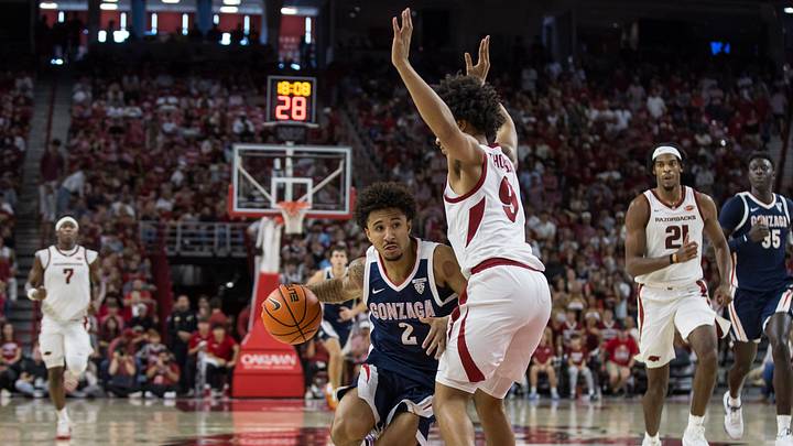 Oct 24, 2026; Fayetteville, AK, USA; Gonzaga Bulldogs guard Javon Bennett (2) drives towards the basket around Arkansas Razorbacks guard Davion Thompson (9) during the second half at Bud Walton Arena. Mandatory Credit: Brett Rojo-Imagn Images Oct 24, 2026; Fayetteville, AK, USA; Gonzaga Bulldogs guard Javon Bennett (2) drives towards the basket around Arkansas Razorbacks guard Davion Thompson (9) during the second half at Bud Walton Arena. Mandatory Credit: Brett Rojo-Imagn Images