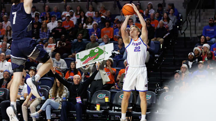 Dec 21, 2024; Gainesville, Florida, USA; Florida Gators guard Bennett Andersen (22) attempts a three point basket against the North Florida Ospreys during the second half at Exactech Arena at the Stephen C. O'Connell Center. Mandatory Credit: Matt Pendleton-Imagn Images