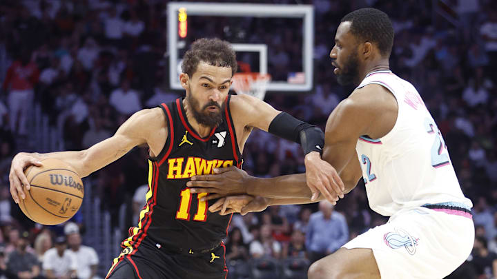 Mar 27, 2025; Miami, Florida, USA;  Miami Heat forward Andrew Wiggins (22) defends Atlanta Hawks guard Trae Young (11) during the second half at Kaseya Center. Mandatory Credit: Rhona Wise-Imagn Images