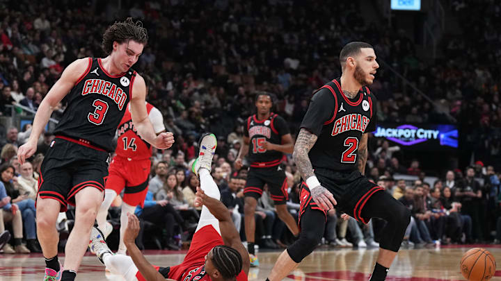 Dec 16, 2024; Toronto, Ontario, CAN; Toronto Raptors guard Ochai Agbaji (30) battles for the ball with Chicago Bulls guard Josh Giddey (3) during the second quarter at Scotiabank Arena. Mandatory Credit: Nick Turchiaro-Imagn Images