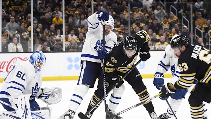 Apr 30, 2024; Boston, Massachusetts, USA; Toronto Maple Leafs defenseman Jake McCabe (22) ties up Boston Bruins center Charlie Coyle (13) in front of goaltender Joseph Woll (60) during the third period in game five of the first round of the 2024 Stanley Cup Playoffs at TD Garden. Mandatory Credit: Bob DeChiara-Imagn Images