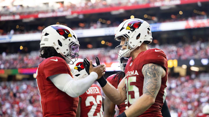 Arizona Cardinals quarterback Kyler Murray celebrates a touchdown with tight end Trey McBride.
