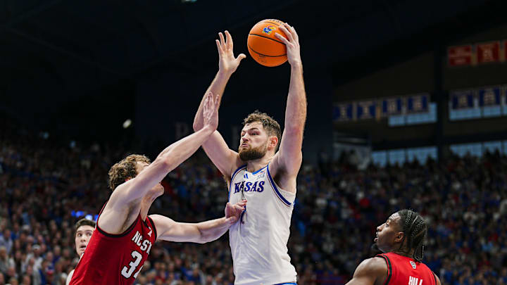 Dec 14, 2024; Lawrence, Kansas, USA; Kansas Jayhawks center Hunter Dickinson (1) goes up for a shot against North Carolina State Wolfpack forward Ben Middlebrooks (34) and guard Marcus Hill (10) during the second half at Allen Fieldhouse. Mandatory Credit: Jay Biggerstaff-Imagn Images Dec 14, 2024; Lawrence, Kansas, USA; Kansas Jayhawks center Hunter Dickinson (1) goes up for a shot against North Carolina State Wolfpack forward Ben Middlebrooks (34) and guard Marcus Hill (10) during the second half at Allen Fieldhouse. Mandatory Credit: Jay Biggerstaff-Imagn Images