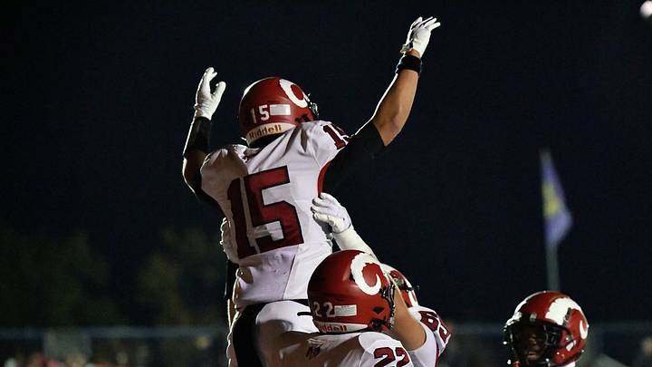 Manual's Noah Price (15) is raised in the air by teammates following his touchdown during second half action of their game against Male, Friday, Oct. 30, 2026 in Louisville Ky.