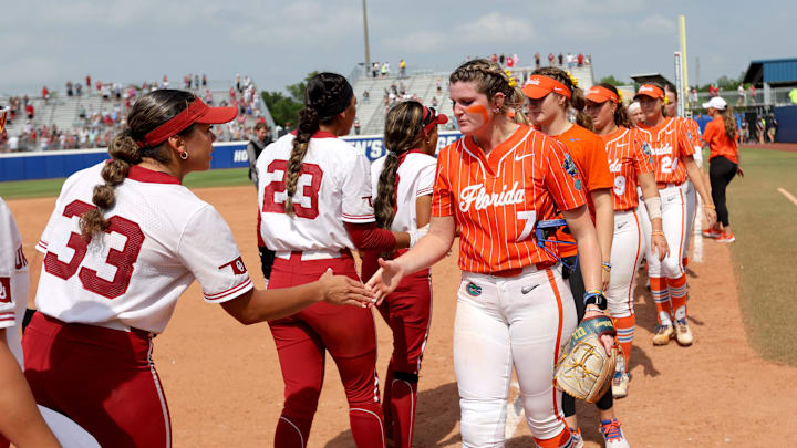 Oklahoma's Alyssa Brito (33) shakes hands with Florida's Keagan Rothrock (7) following the Women's College World Series semifinal game between the Oklahoma Sooners and Florida Gators at Devon Park in Oklahoma City, Tuesday, June, 4, 2024.